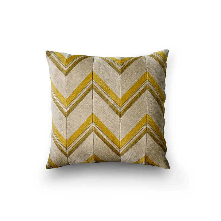 Decorative pillow with yellow and beige chevron pattern on a white background